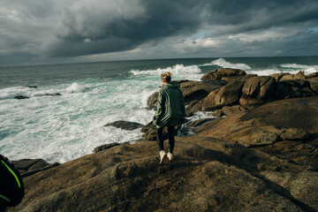 tourist on Punta de la Barca in the fishing village of Muxia, Costa da Morte, Galicia, Spain