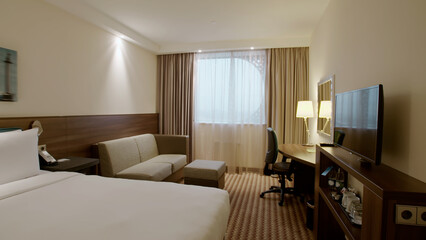 Modern hotel bedroom with large white bed interior