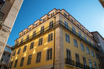 Fototapeta premium Lisbon, Portugal, facade of an old house with windows, European historical buildings, cozy cityscape, Portuguese streets landscape, view of city