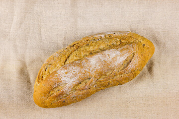 Multigrain bread. Multigrain loaf. Fresh fragrant bread on on fabric