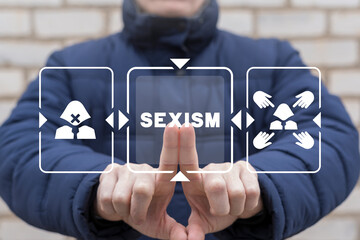 Man using virtual touch screen presses word: SEXISM. Concept of no and stop sexism. Examine and...