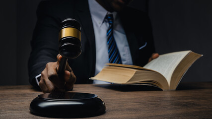 Lawyer showing judge gavel . Business Man hold judge gavel , lawyer or attorney concept. lawyer holding judge gavel in courtroom,  Court of Law and Justice Trial Session