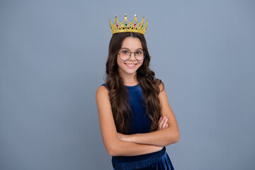 Teenager princess child celebrates success win and victory. Teen girl in queen crown. Happy girl smiling. © Olena