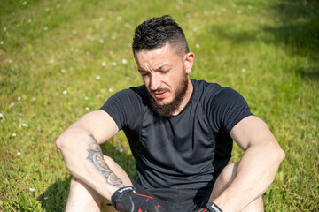 portrait d'un sportif au repos dans l'herbe