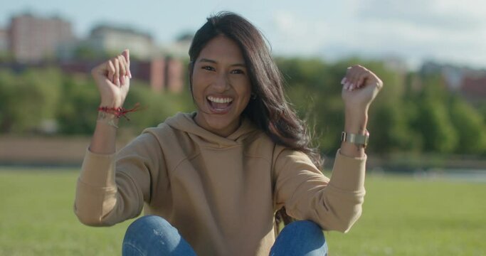 Close-up happy young teen latina college student in a park