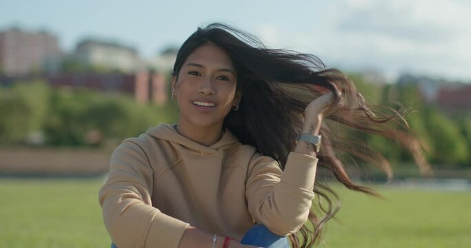 Close-up happy young teen latina college student in a park