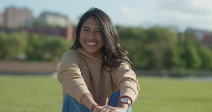 Close-up happy young teen latina college student in a park