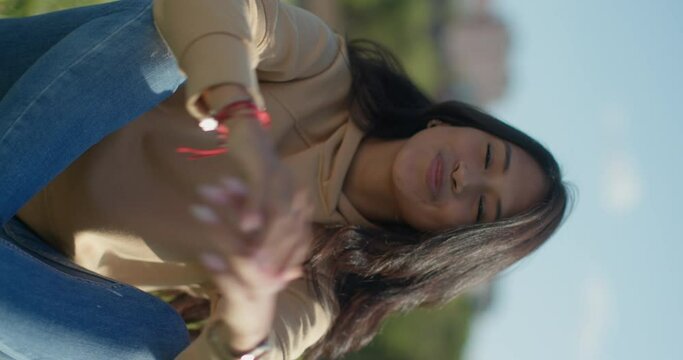Close-up happy young teen latina college student in a park, vertical shot