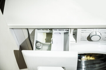 A cubicle for the dosing of soap, bleach and fabric softeners