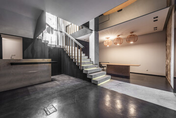 Ground floor of an empty retail space with displays of marble tiles and polished concrete floors