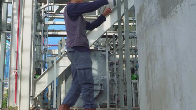 Young worker walk then climb up and down of monkey ladder. The footage is suitable to use for industry footage promotion and safety content media.