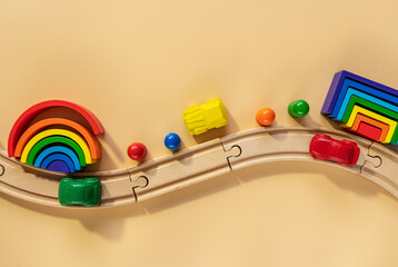 Multicolored wooden kids toys on beige background. Educational toys blocks, rainbow. Toys for...