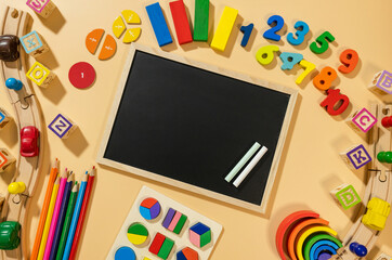Set of charts on beige background. School blackboard and wooden math fractions on the table. Back to school, creative study for kids, education, mathematics. flat lay	