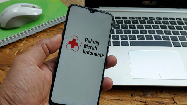 Bekasi, Indonesia - April 2,2022: PMI or palang merah indonesia on smartphone, popular health organization in Indonesia