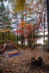 Stunning sunset from a camping site with beautiful fall foliage by a lake