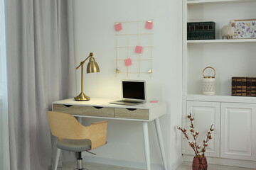 Stylish teenager's room interior with workplace and beautiful design elements