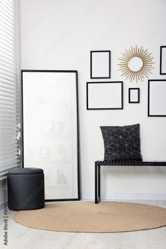 Canvas Prints Stylish room interior with empty frames hanging on white wall and comfortable furniture