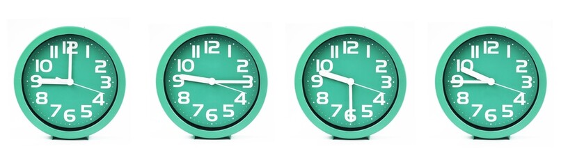 close up of a set of green clocks showing the time; 9, 9.15, 9.30 and 9.45 p.m or a.m. Isolated on white background
 - obrazy, fototapety, plakaty