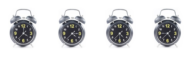 close up of a set of black alarm clocks showing the time; 4, 4.15, 4.30 and 4.45 p.m or a.m. Isolated on white background
 - obrazy, fototapety, plakaty