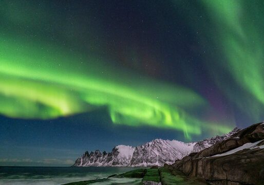 The Aurora Borealis (Northern Lights) over The Devils Jaw (The Devils Teeth), Oskornan mountains, Tungeneset, Senja, Troms og Finnmark County, Norway