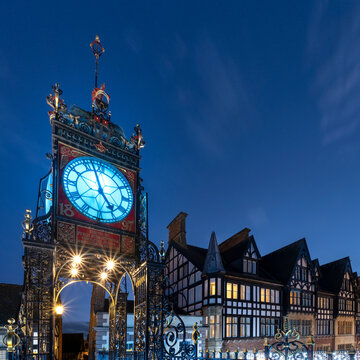 The Victorian Eastgate Clock on the city walls at night, Eastgate Street, Chester, Cheshire, England, United Kingdom