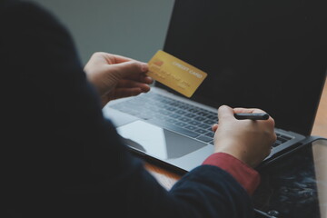 Women holding credit card and using smartphones at home.Online shopping, internet banking, store online, payment, spending money, e-commerce payment at the store, credit card, concept