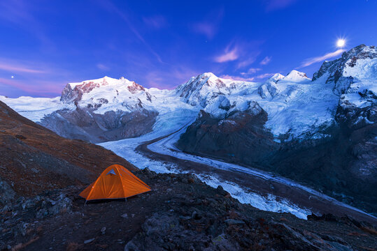 View of the Swiss side of Monte Rosa massif and Gorner glacier (Gornergletscher) with majestic Lyskamm peaks seen from Riffelsee Lake at dusk, Zermatt, Canton of Valais, Visp, Switzerland
