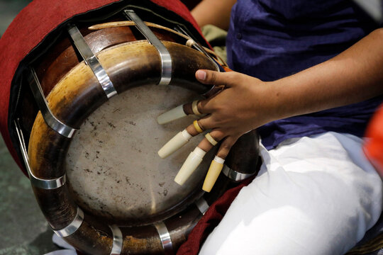 Sri Krishnan Hindu temple, musician playing a Thavil, a traditional Indian drum, Hindu ceremony, Singapore