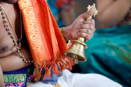 Hand holding ceremonial bell, Sri Srinivasa Perumal Hindu temple, Hindu priest (Brahmin) performing puja ceremony and rituals, Singapore