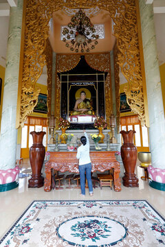 Tinh Xa Ngoc Chau pagoda, Buddhist altar and woman praying to the Buddha, Chau Doc, Vietnam