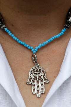 Woman wearing a Muslim hamsa amulet (the Hand of Fatima) (the Hand of Mary), Vietnam