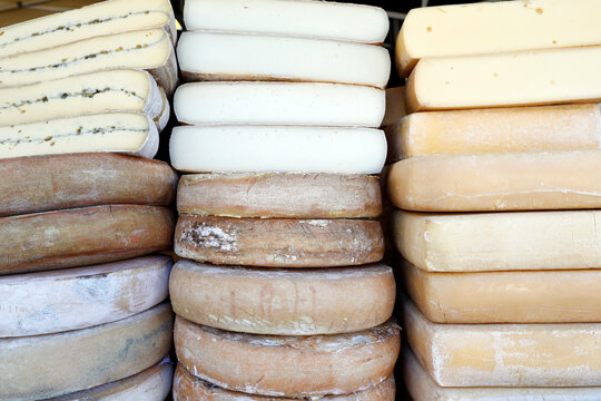 Traditional French cheese, Raclette and Morbier, mountain cheese for sale at market, France