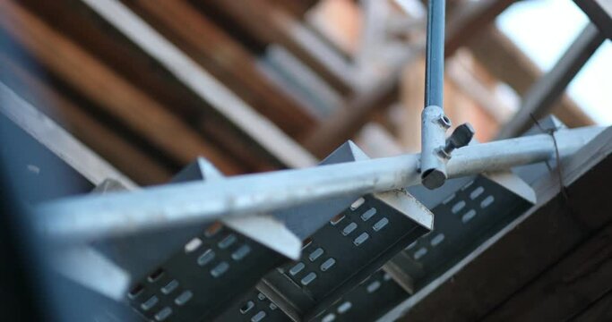 Metal scaffolding at an infrastructure project. The shifting frame of view suggests the dynamism and development of the construction site.