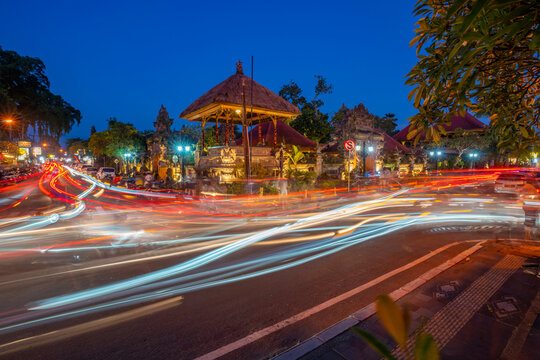 View of car trail lights and Ubud Palace at dusk, Ubud, Kabupaten Gianyar, Bali