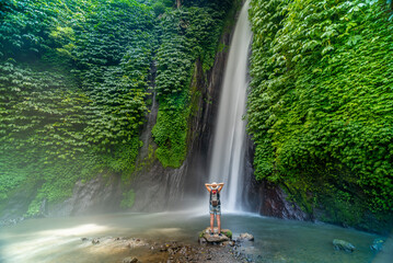 View of woman taking picture at Melanting waterfall, Kabupaten Buleleng, Gobleg, Bali