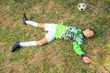 Injured youth soccer player goalie lying unconscious on the field 
