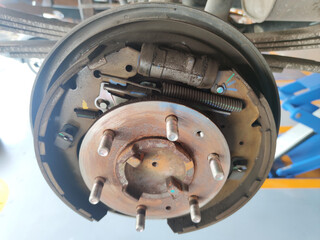 rusty car drum brake without cover hub, maintenance brake system at car auto garage shop