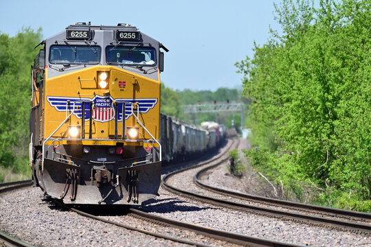 With its train strung out behind, a locomotive leads an Union Pacific intermodal freight train into a curve while traveling through northeastern Illinois destined for Chicago.