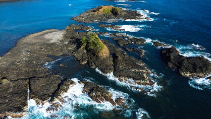 Drone photo of three big rocks formation working as a natural breakwater for Pacific Ocean beach at Pedasi, Panama. 