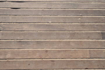 Wooden boardwalk floor with beach sand. Copy space