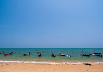 Obraz premium landscape look view point Small fishing boat wooden parked coast sea beach. after fishing of fishermen in small village It small local fishery. Blue sky, white clouds clear weather