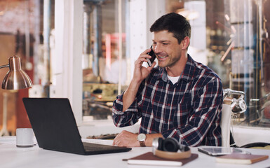 Phone call, laptop and male carpenter in the workshop doing research for a carpentry project. Communication, technology and man industrial worker on a mobile conversation working in warehouse office.