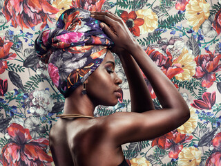 Fashion, beauty and face of black woman on flower background with glamour, cosmetics and makeup. Floral pattern, designer and profile of female person in exotic jewelry, African style and head scarf