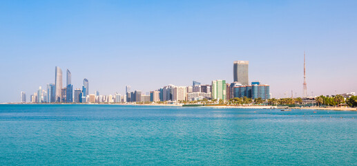 Naklejka premium View of Abu Dhabi with sea, beach and skyscrapers. Travel in UAE