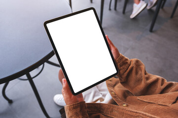 Mockup image of a woman holding digital tablet with blank white desktop screen in cafeMockup image of a woman holding digital tablet with blank white desktop screen in cafe