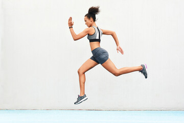 Woman, fitness and running on mockup of athlete in cardio training, workout or healthy exercise. Fit, active or sporty female person or runner exercising for health and wellness on wall mock up space