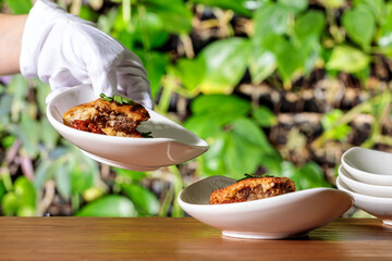 hands holding a bowl of food