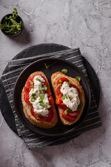 bruschetta with tomatoes and strachatella cheese