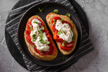 bruschetta with tomatoes and strachatella cheese