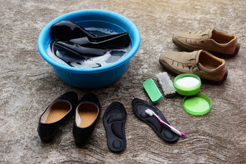 Shoes, wash on bowl, brush, old toothbrush and detergent to clean and scrub. Concept, take care,...